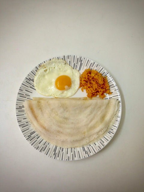 a plate of food that includes an egg and a pita bread