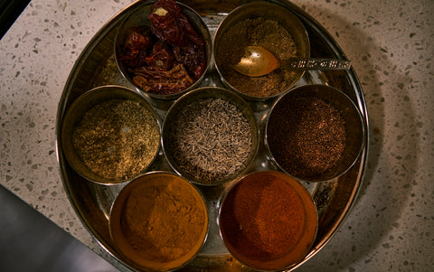 a group of small containers with brown liquid in them
